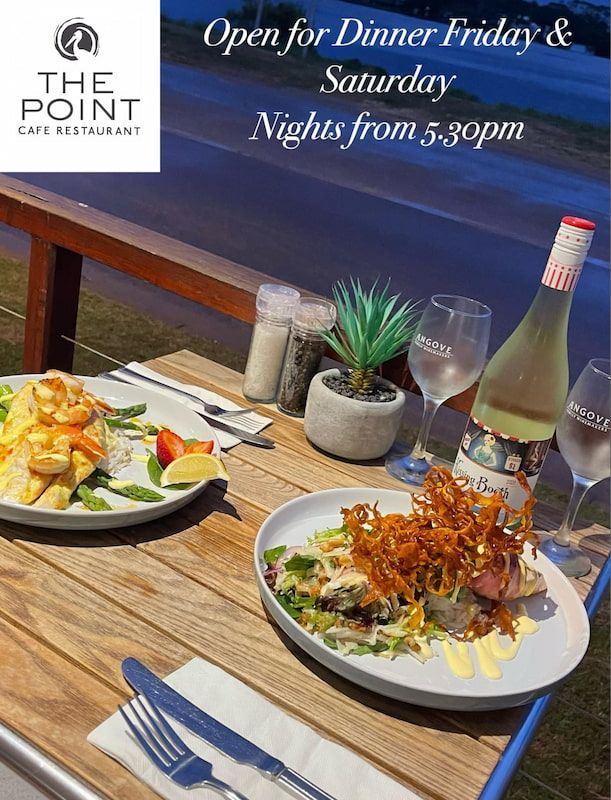 A Wooden Table Topped with Two Plates of Food and A Bottle of Wine — The Point Cafe Restaurant in Port Macquarie, NSW