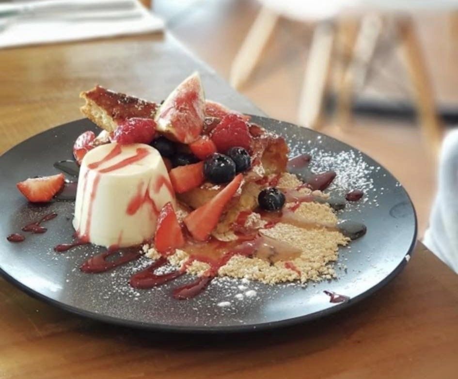 A Dessert with Strawberries and Blueberries on A Black Plate — The Point Cafe Restaurant in Port Macquarie, NSW