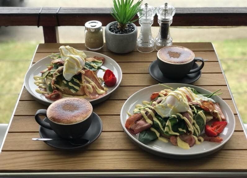 Three Plates of Food and Two Cups of Coffee on A Wooden Table — The Point Cafe Restaurant in Port Macquarie, NSW