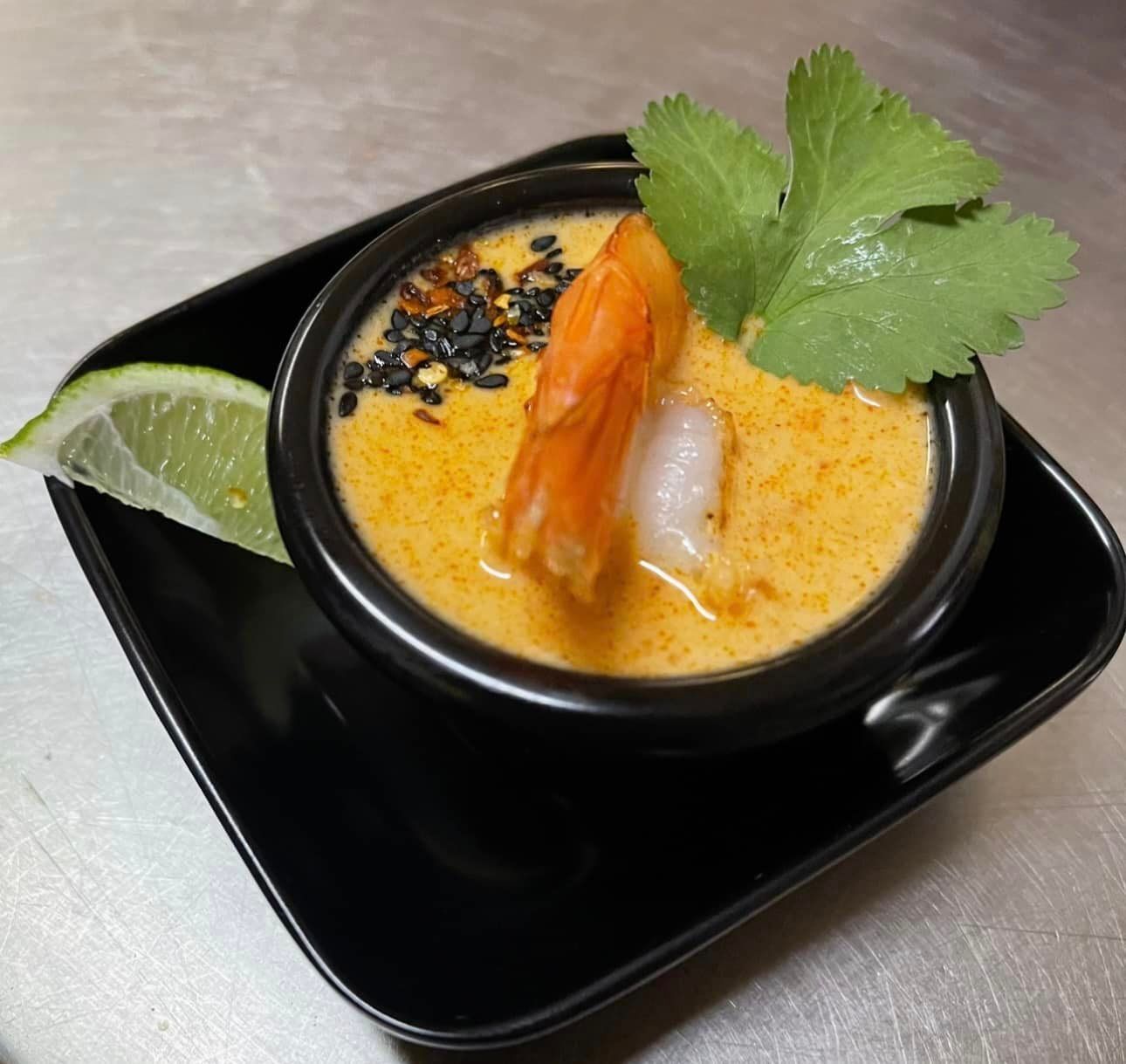 A Bowl of Soup with Shrimp and Cilantro on A Black Plate — The Point Cafe Restaurant in Port Macquarie, NSW