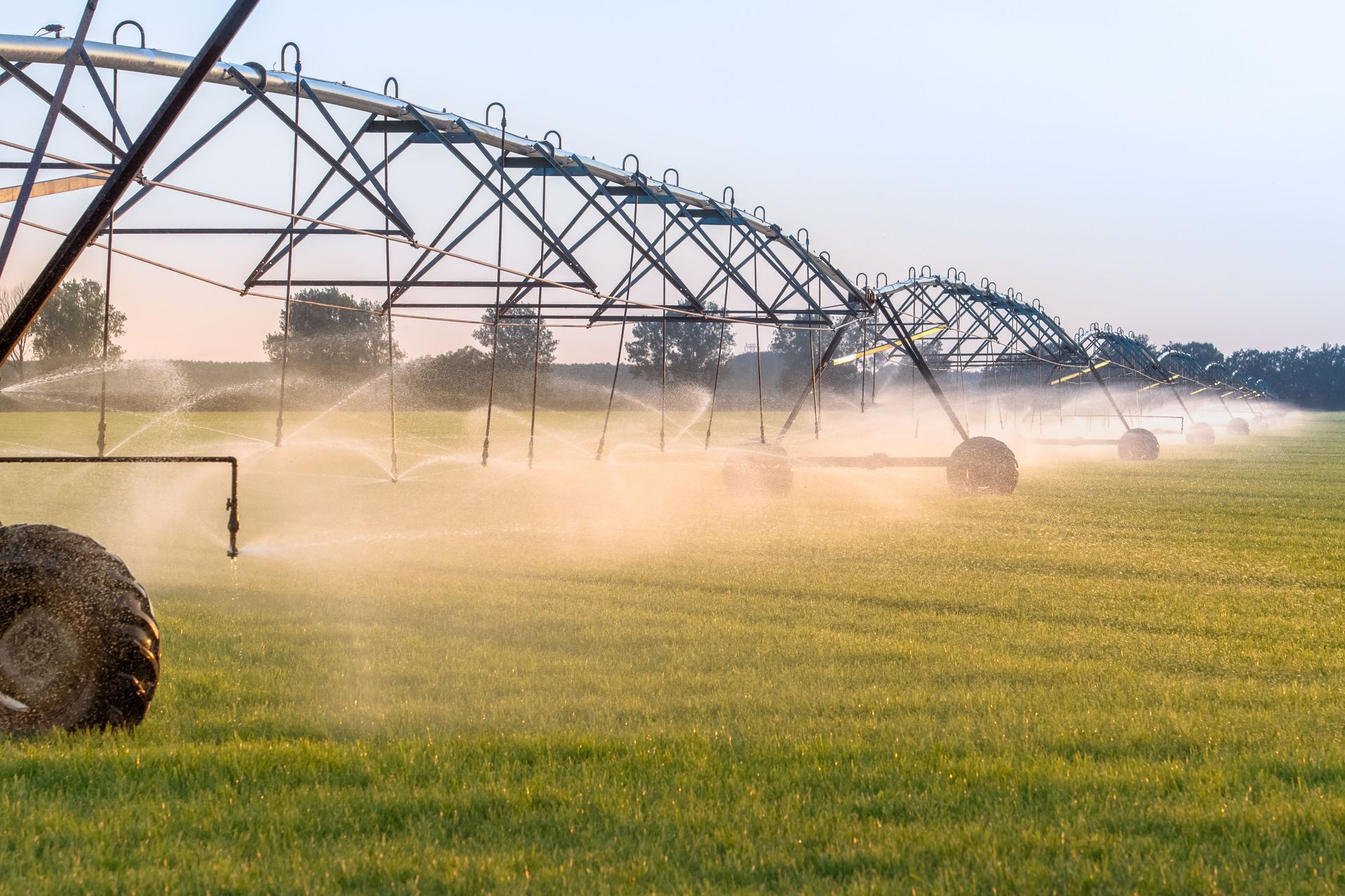 Center pivot irrigation system watering crops on multi acre farm.