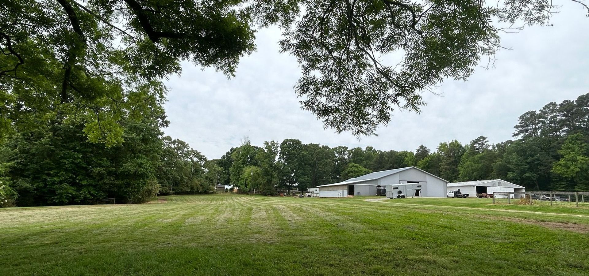 wide open spaces with a white barn in the background