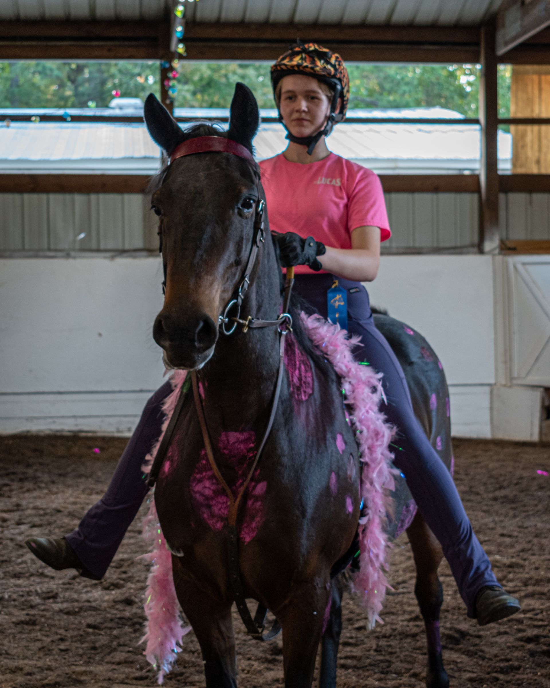a little girl wearing a dress standing next to a white horse