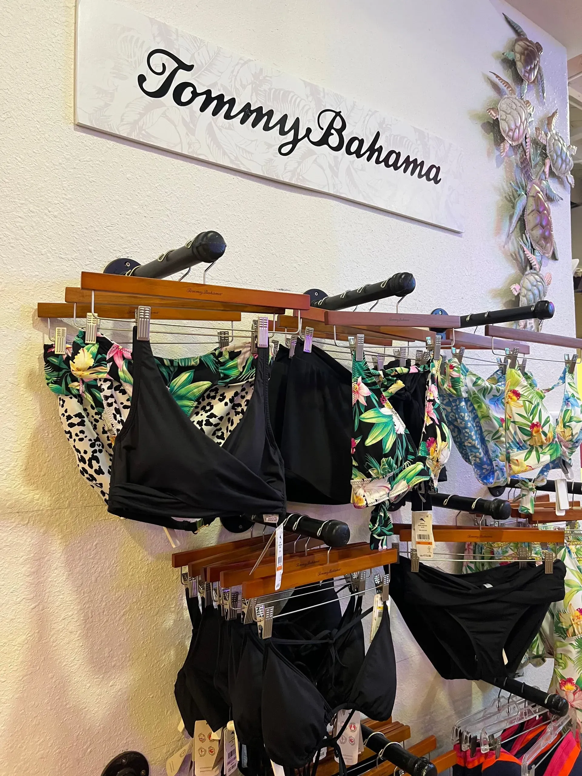 Tommy Bahama swimwear display with black and patterned bikinis.