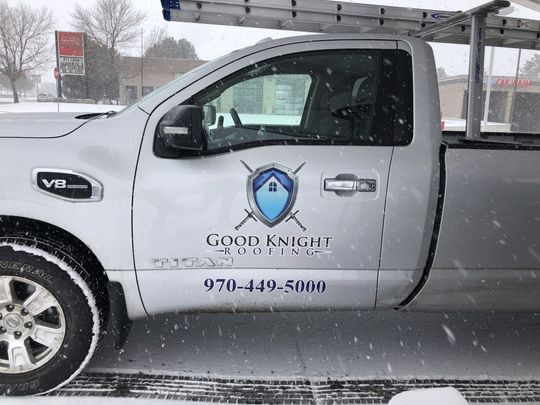 A good knight truck is parked in the snow