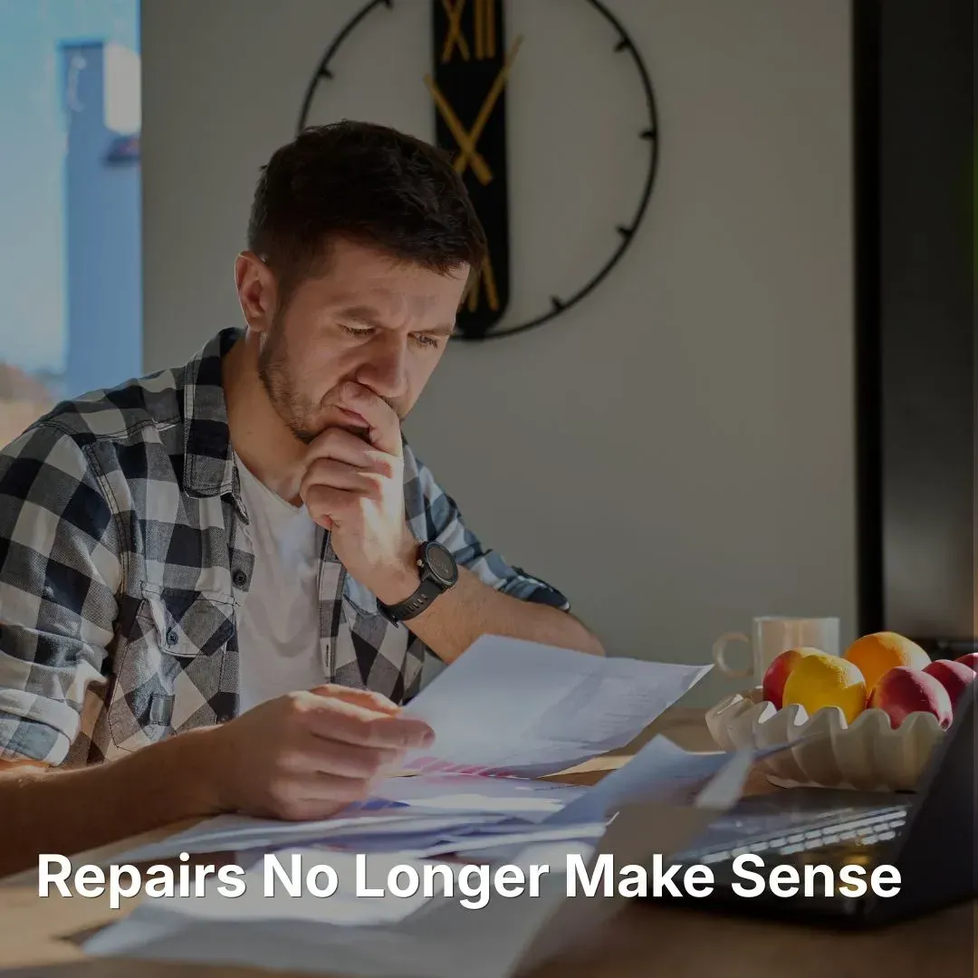 Roof repair cost no longer make sense. Man looking through roof repair bills.