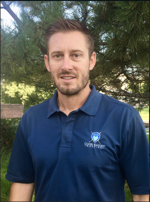 A man wearing a blue shirt with a logo on it