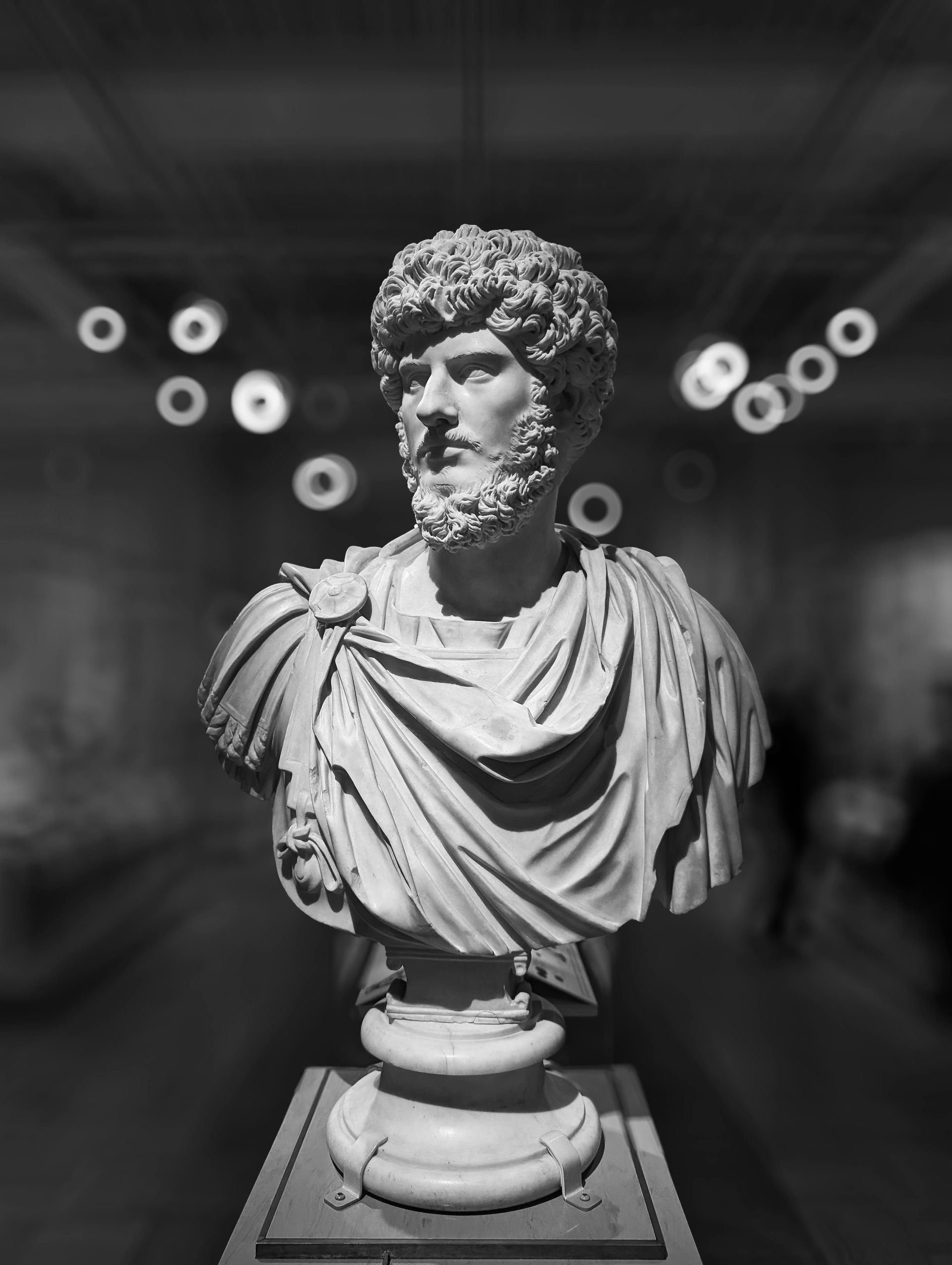 A black and white photo of a statue of a man with a beard