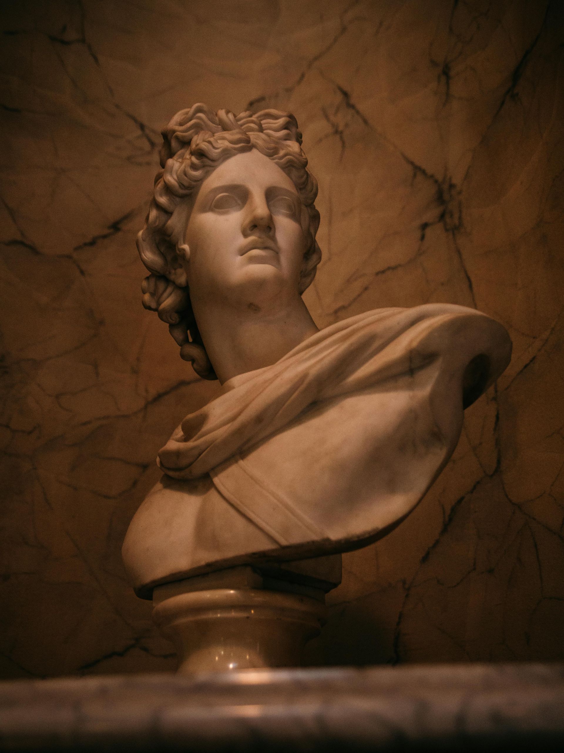 A statue of a woman 's head on a pedestal