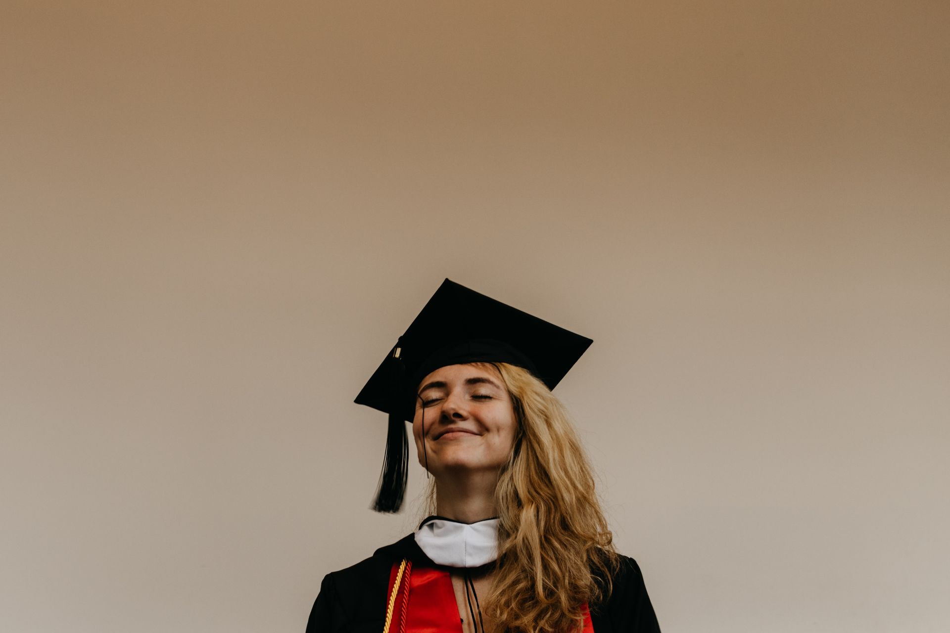 Girl in graduation regalia smiling