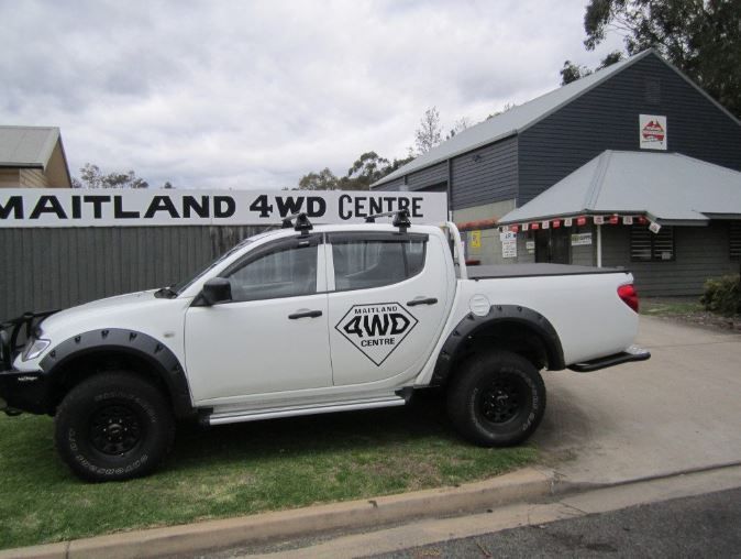 A White 4wd Truck Is Parked In Front — Maitland 4WD Centre In Maitland, NSW