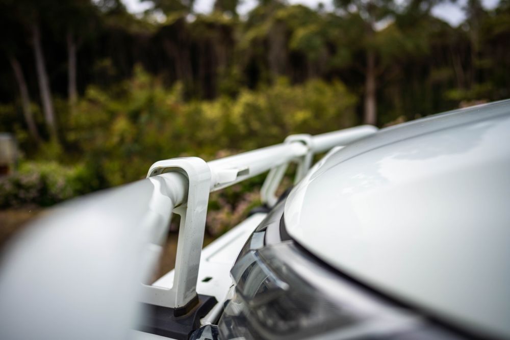 A Close Up Of A White Car With A Roof Rack On The Hood — Maitland 4WD Centre In Singleton, NSW