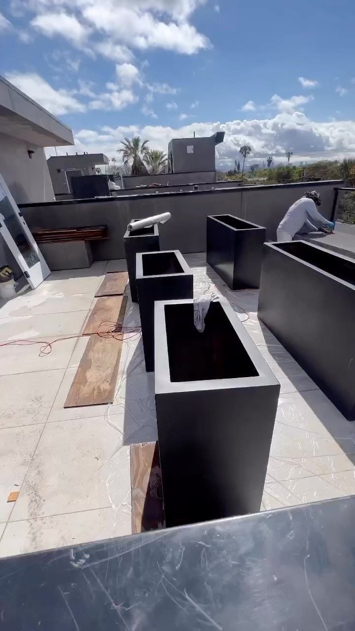 A group of planters are sitting on top of a roof.
