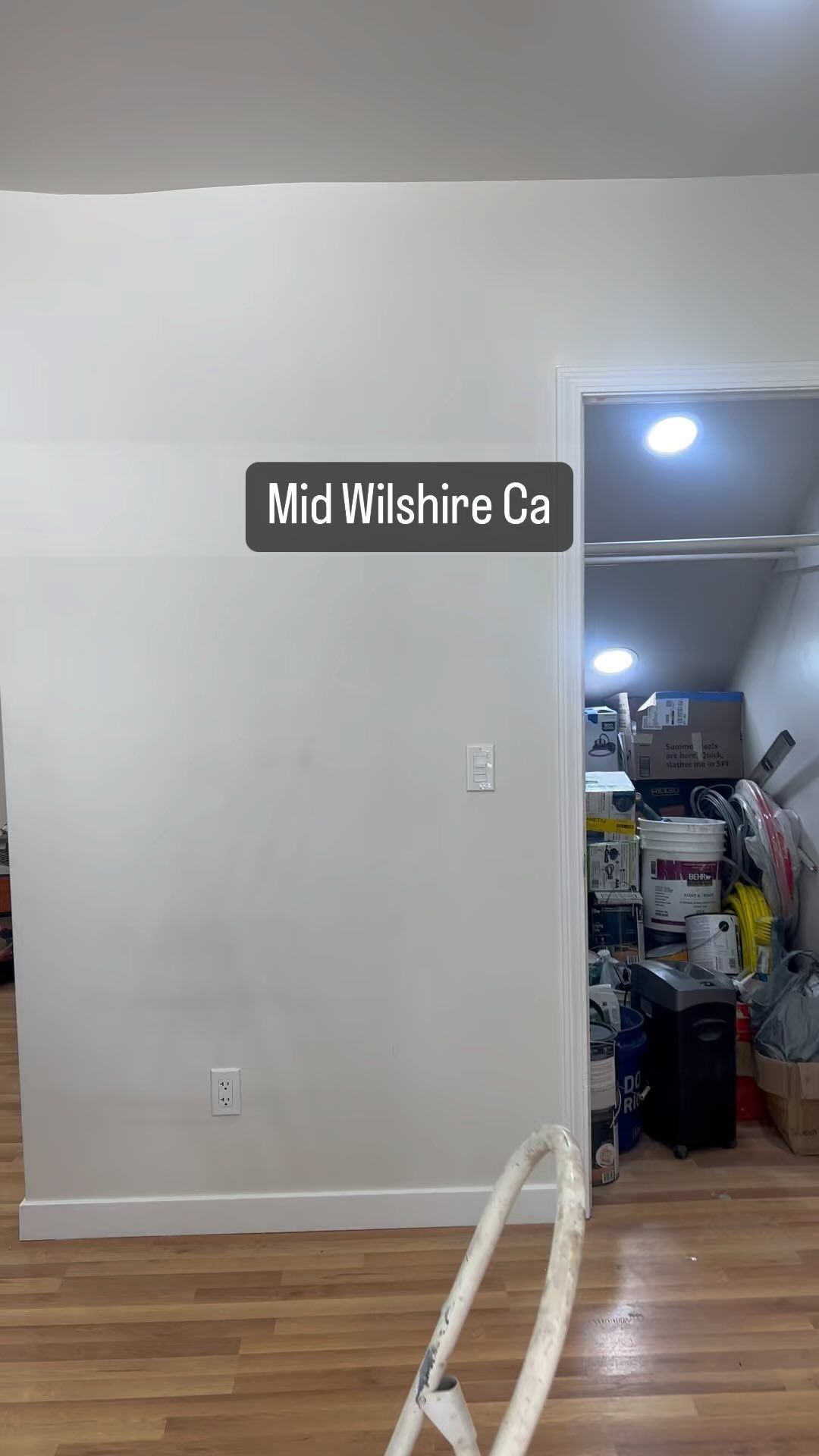 A closet with a sign on the wall that says mid wilshire ca.
