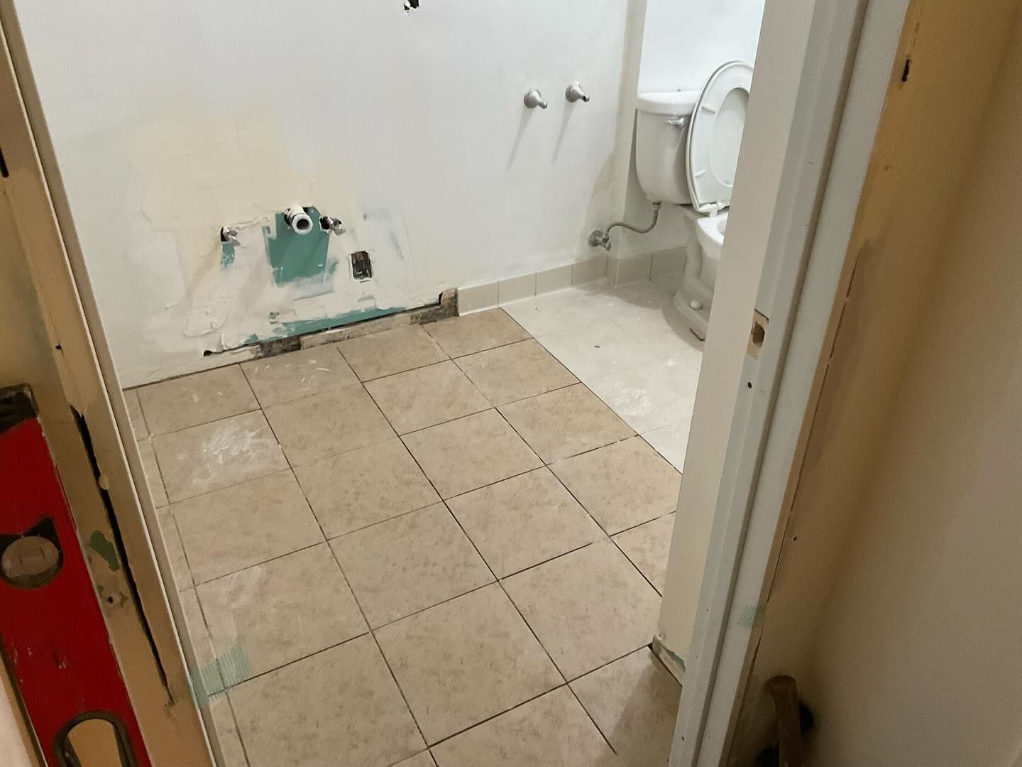 A bathroom with tile floors and a toilet.