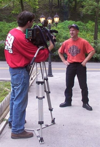 A man wearing a red shirt with the number 50 on it