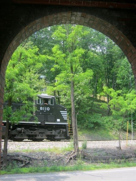 A train with the number 6110 on the side of it