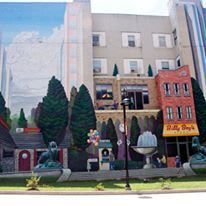 A large building with a mural on the side of it.