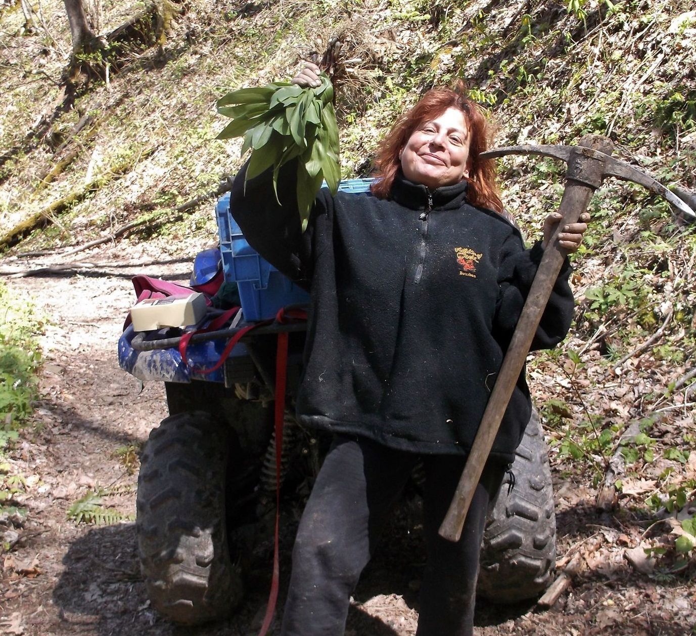 A woman in a black jacket is holding a pickaxe