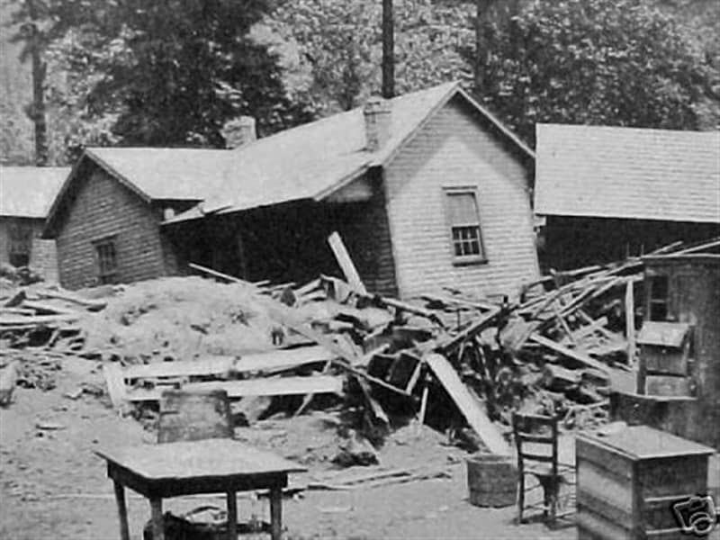 A black and white photo of a house that has been demolished