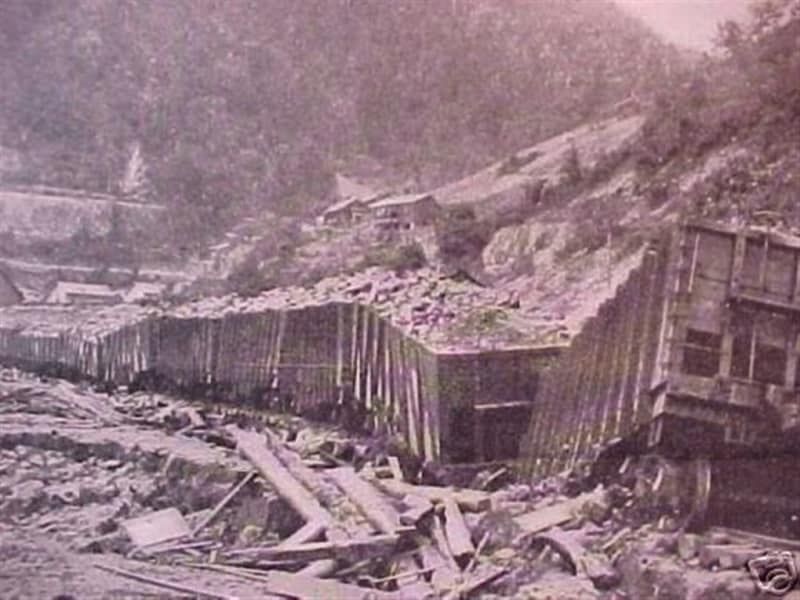 A black and white photo of a train going down a hill