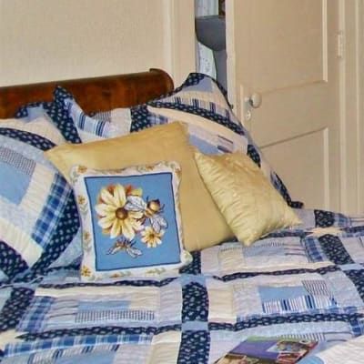 A bed with a quilt and pillows on it