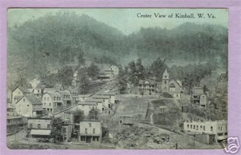 A black and white photo of a small town in the mountains