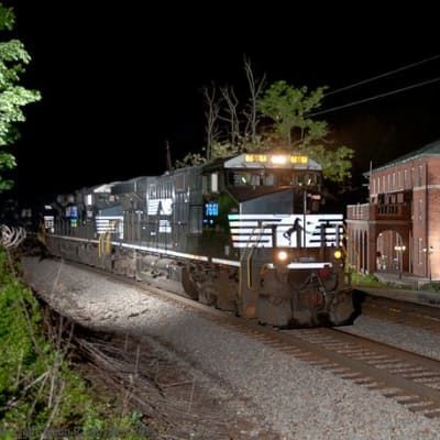 A train is going down the tracks at night.