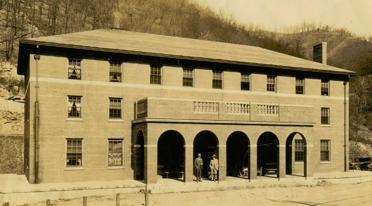 A black and white photo of a large brick building