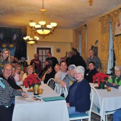 A group of people are sitting at tables in a room