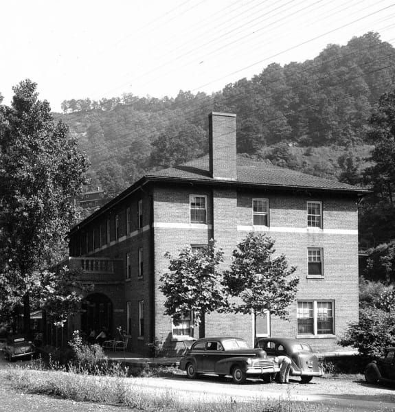 A black and white photo of a large brick building