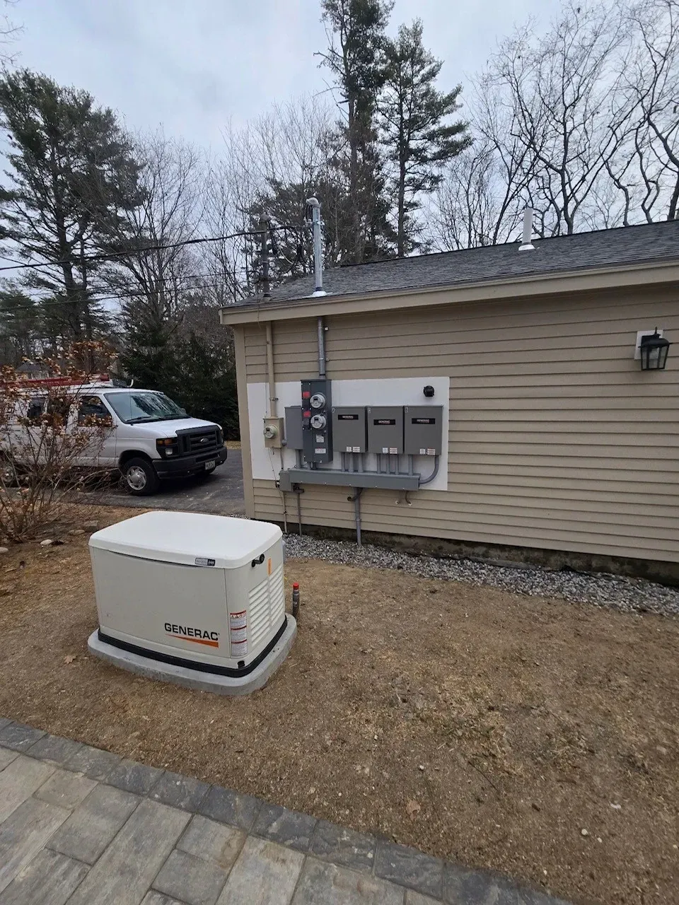 A generator is sitting in front of a house.