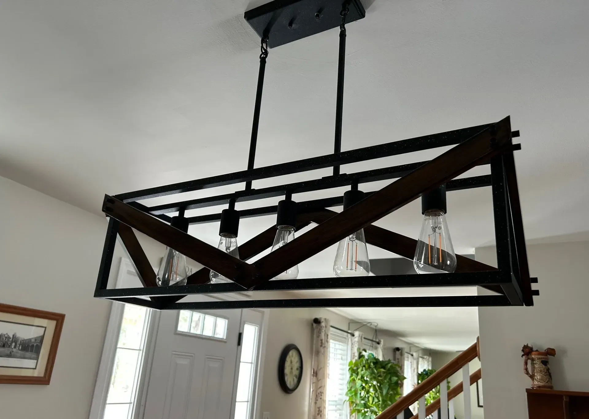 A chandelier is hanging from the ceiling in a living room.
