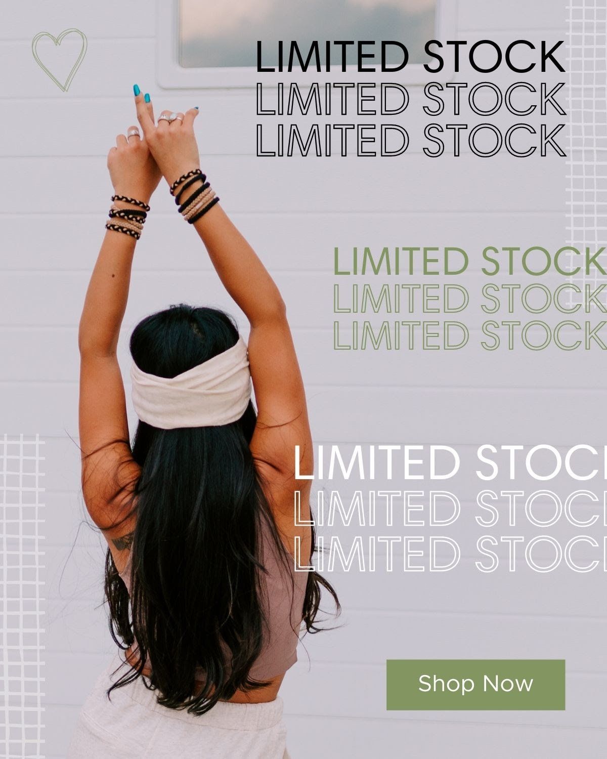 A woman is standing with her arms in the air.