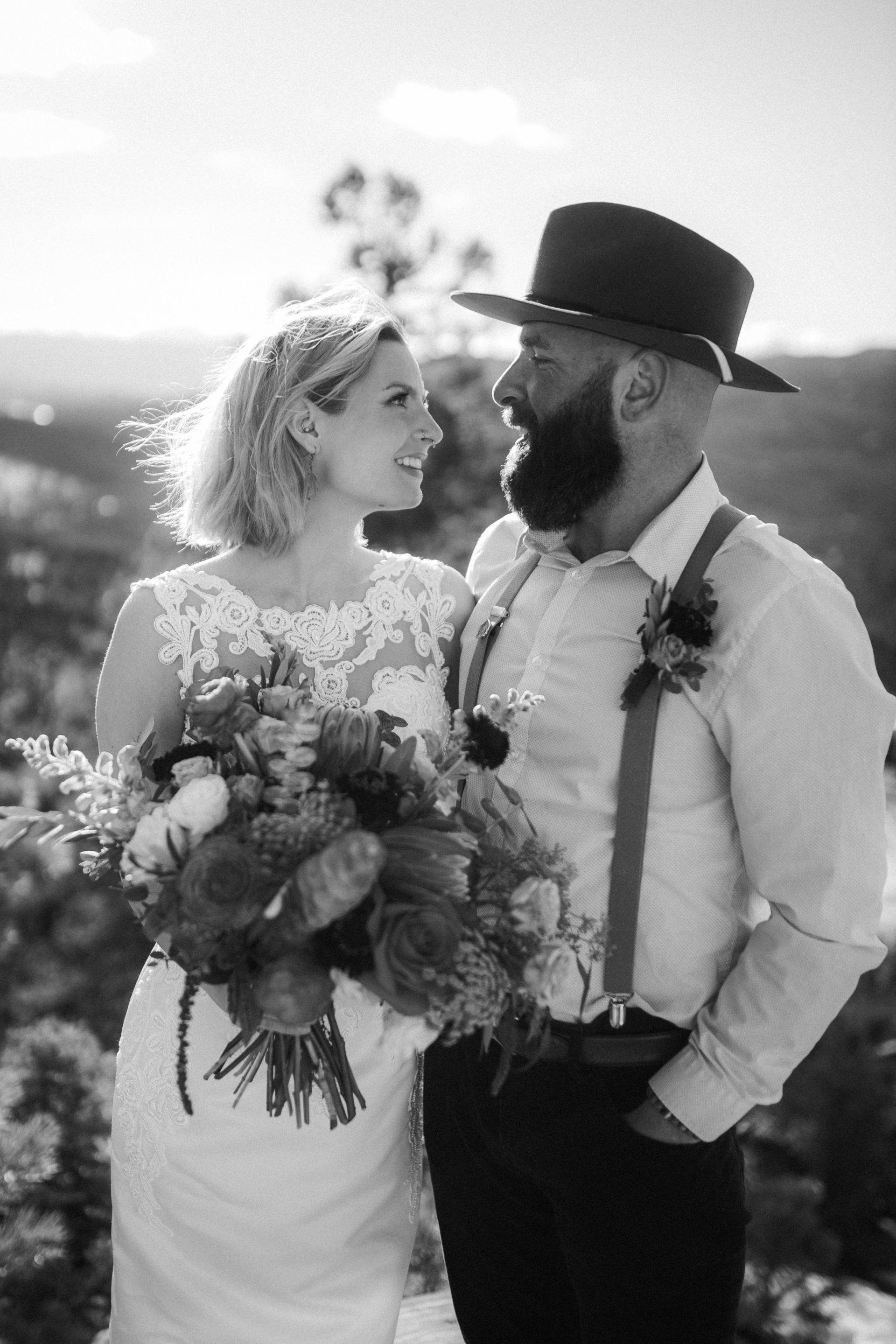 A black and white photo of a bride and groom standing next to each other.