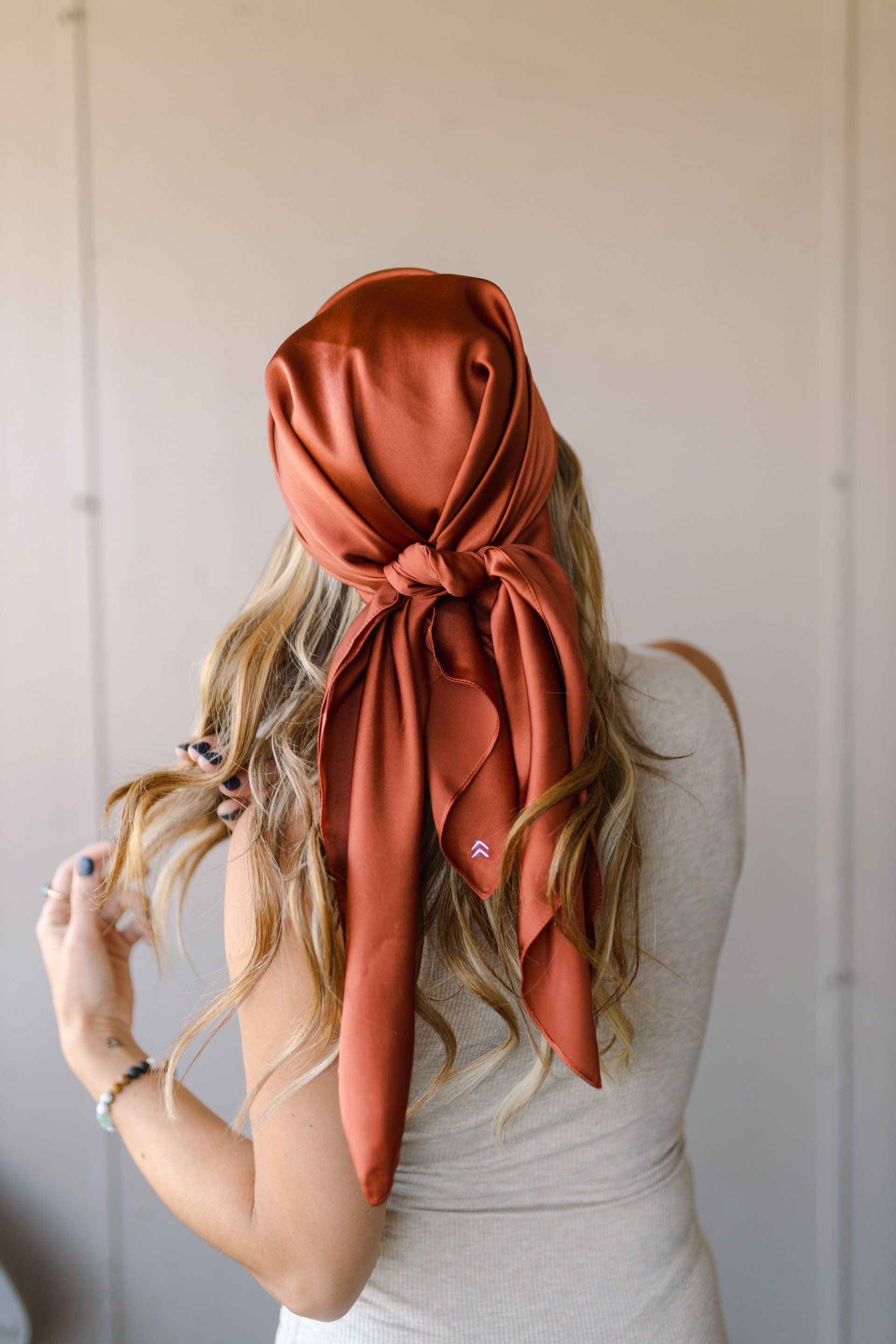 A woman is wearing a scarf around her head.