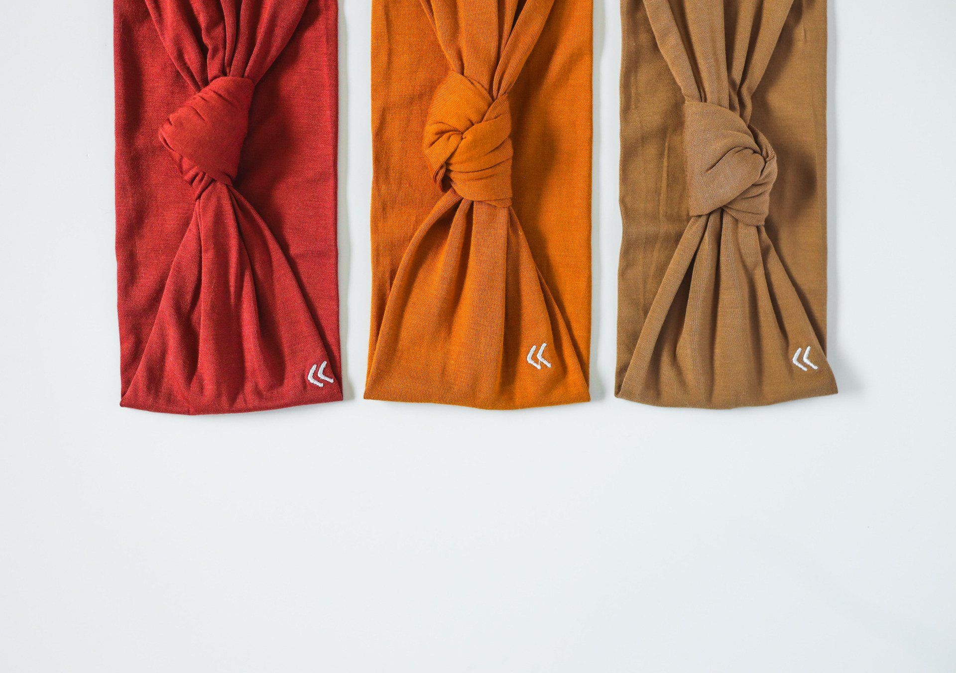 Three headbands are sitting next to each other on a white surface.