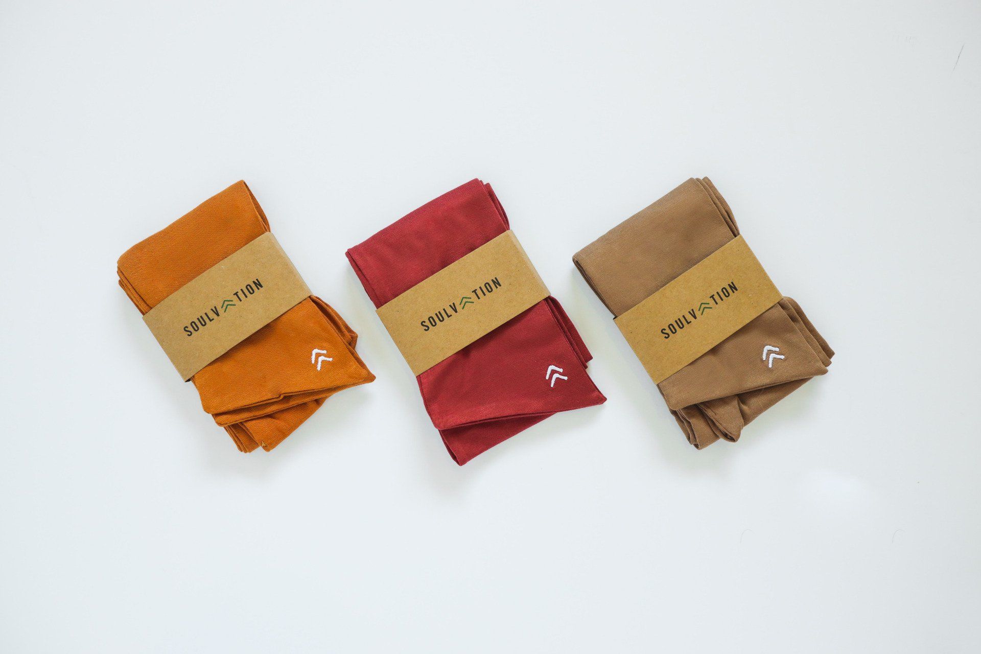 Three pairs of socks are sitting next to each other on a white surface.