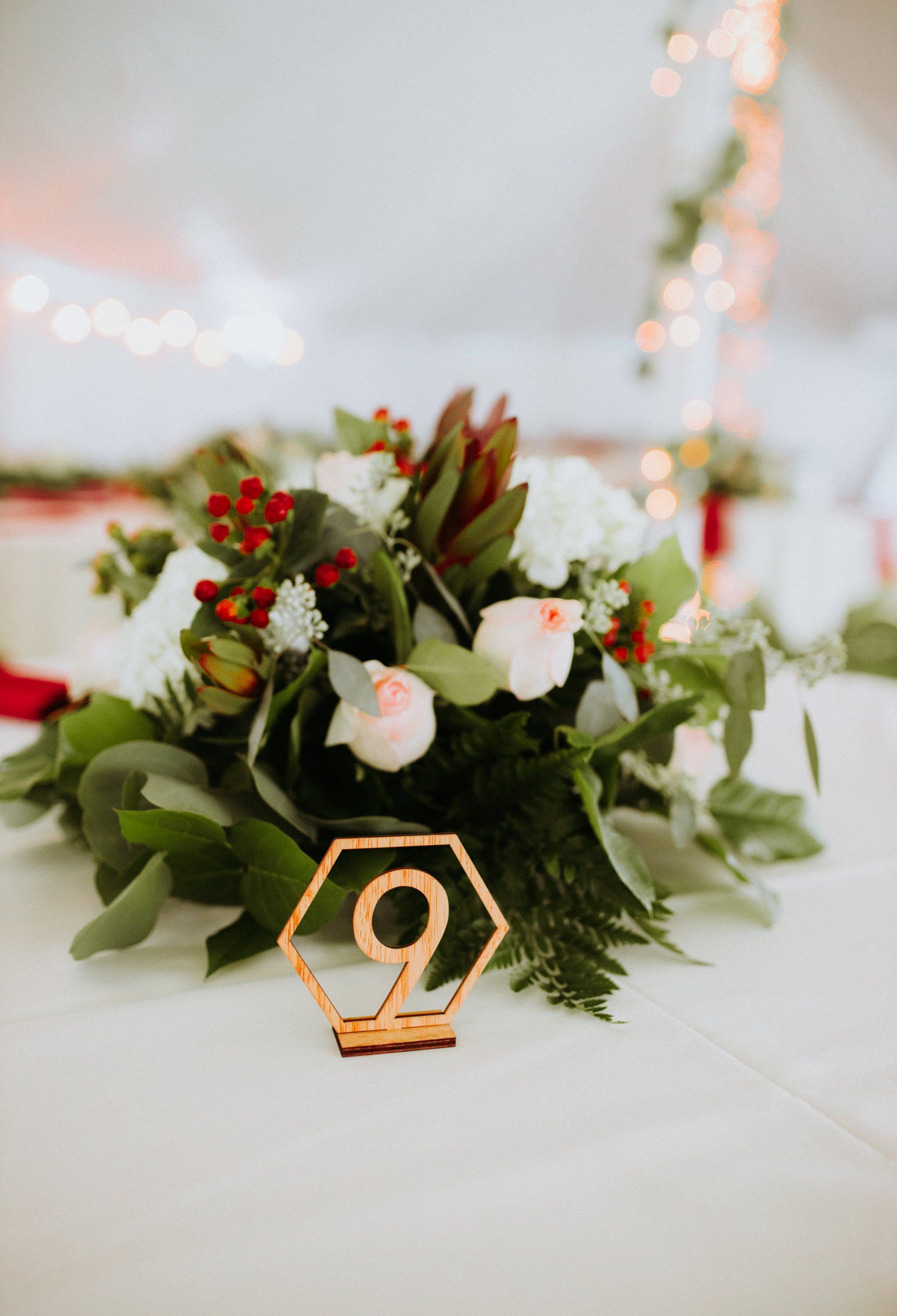 A table with flowers and a table number on it.