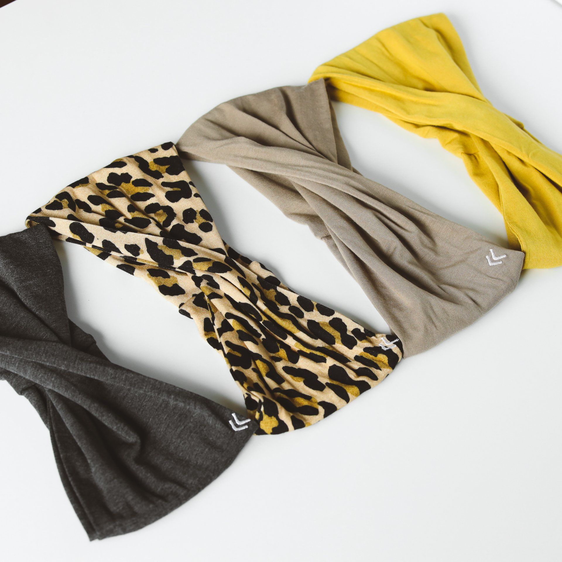 Three different colored headbands are on a white surface