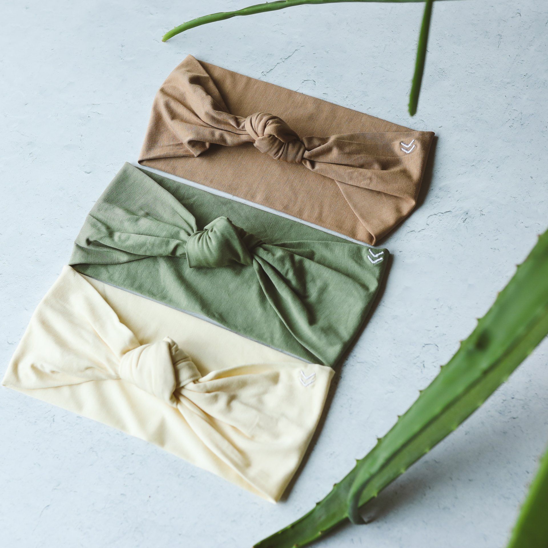 Three headbands are stacked on top of each other on a table