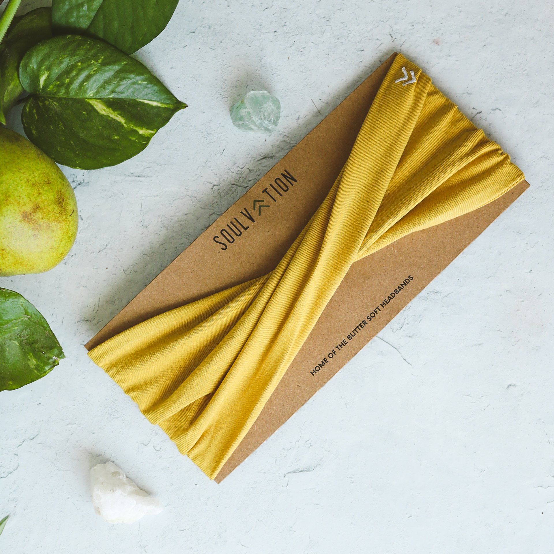 A yellow headband is on a card that says soulvation