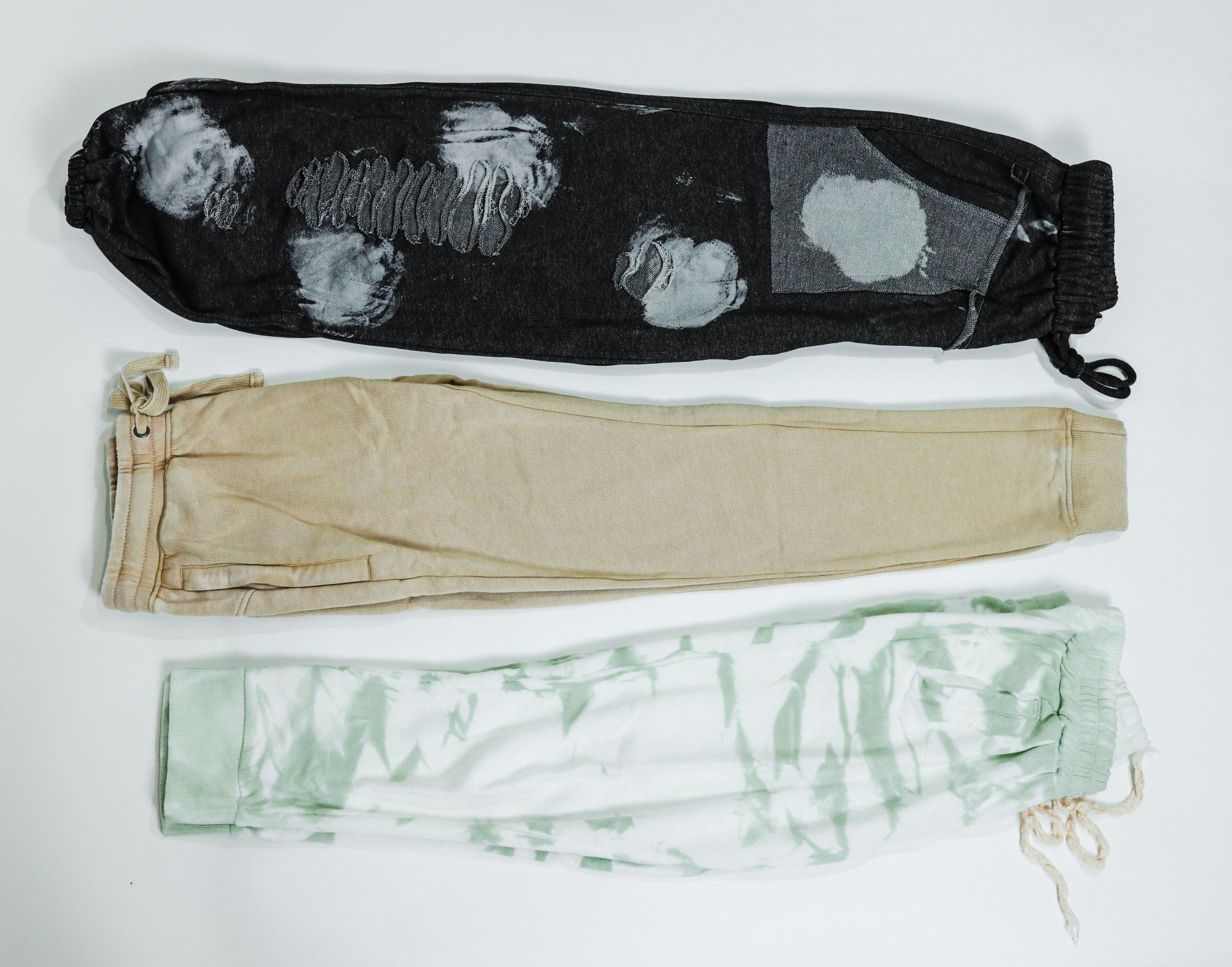 Three different colored socks are stacked on top of each other