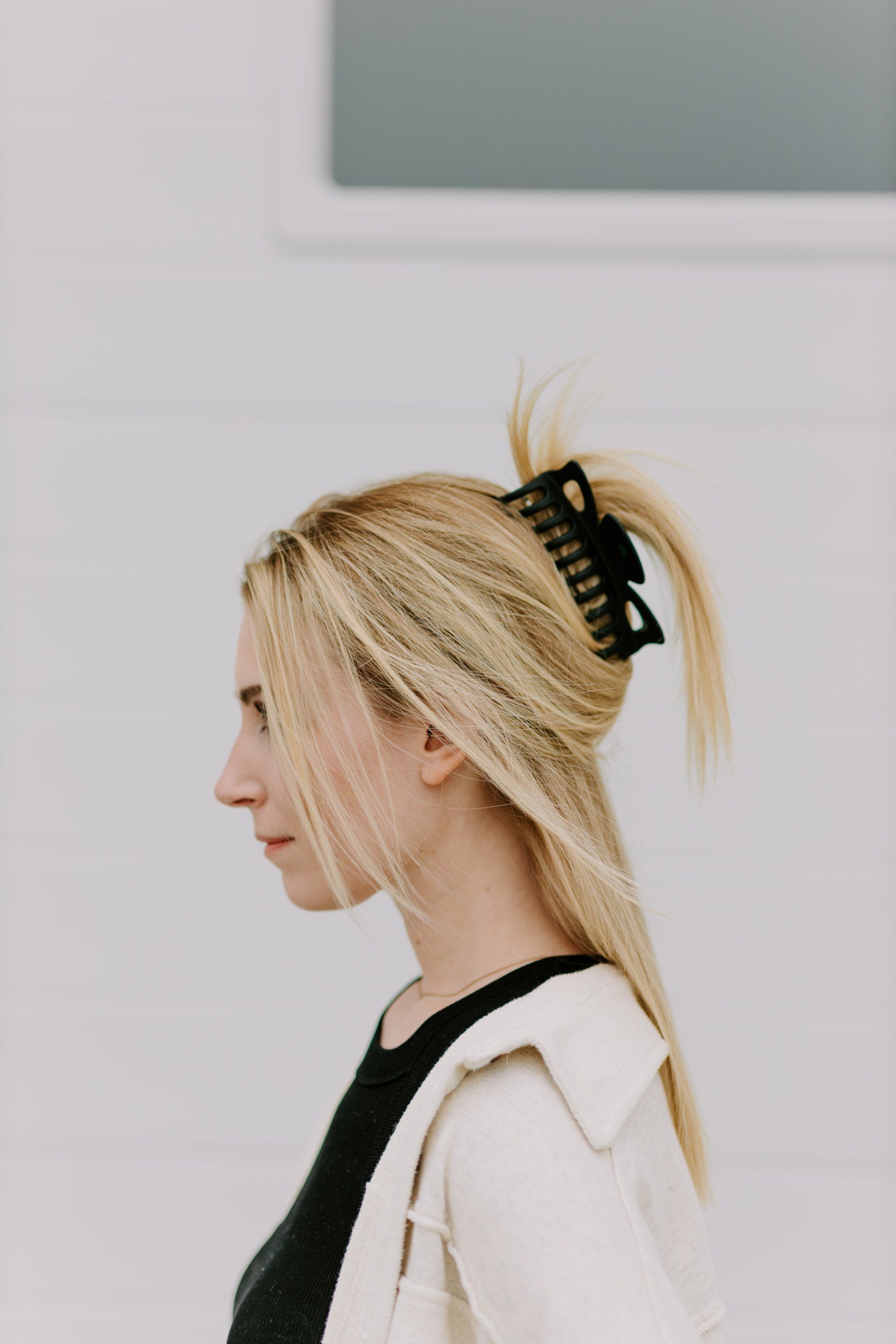 A woman is wearing a black hair clip in her hair.