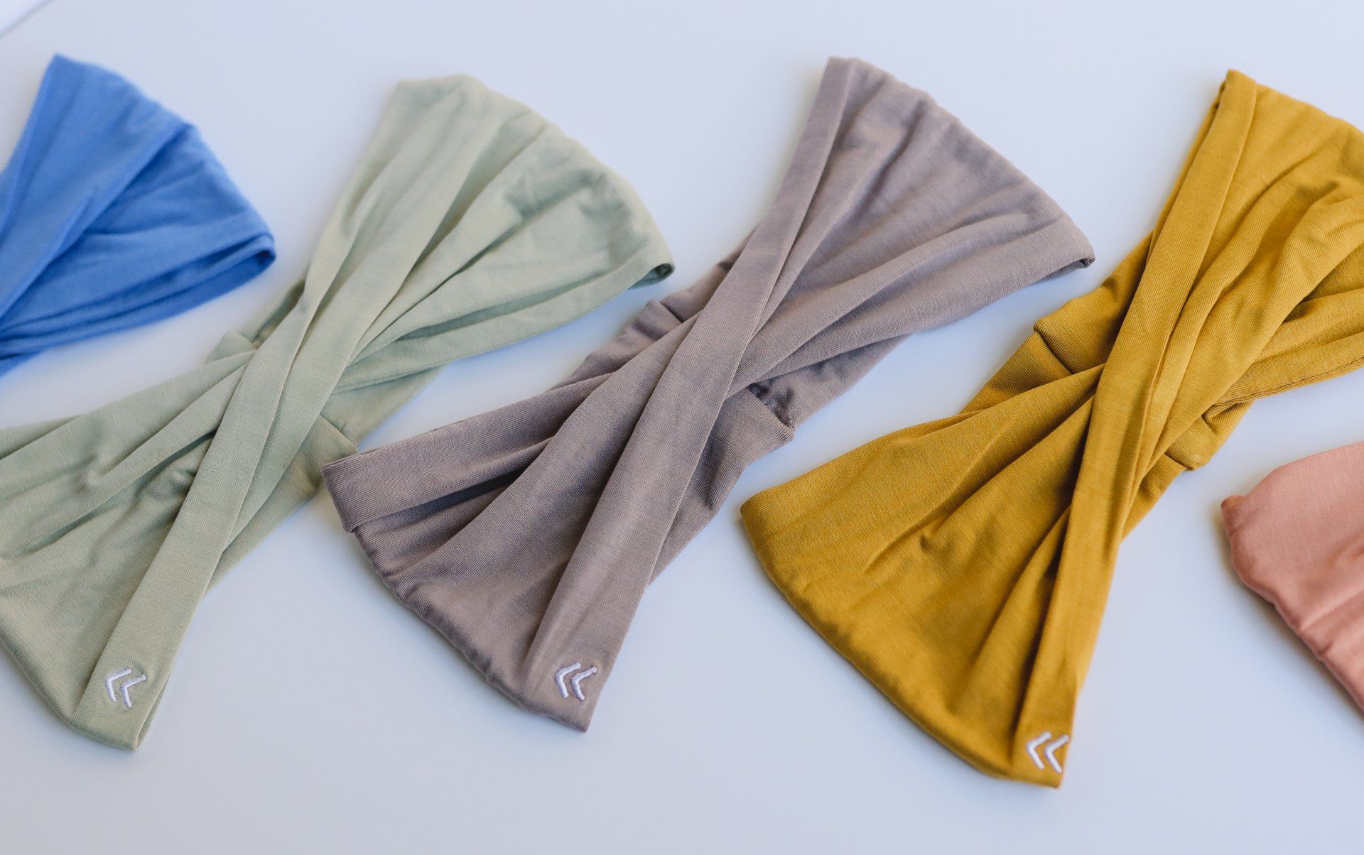 A group of headbands of different colors are sitting on a table.