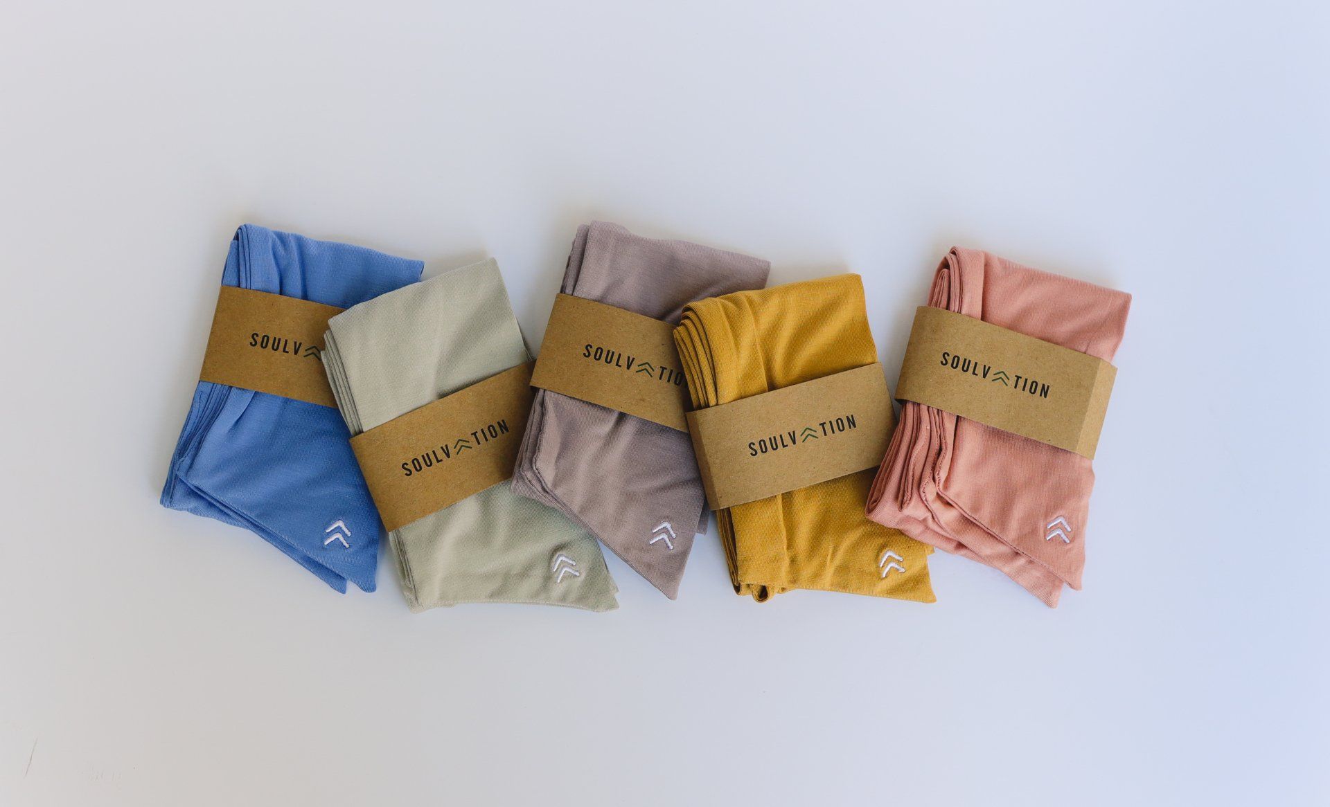 A group of clothes are sitting on top of each other on a table.