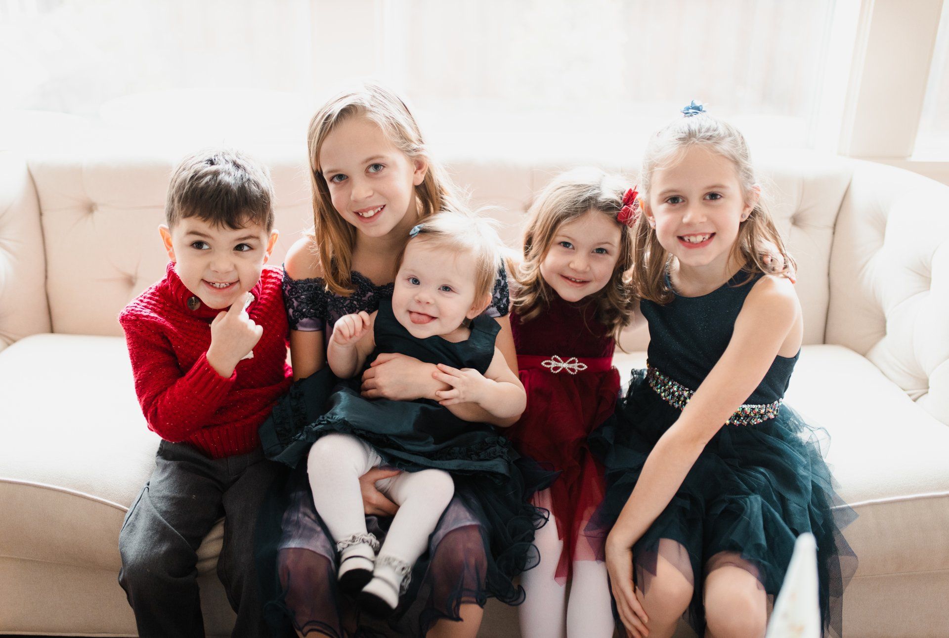 A group of children are sitting on a couch.