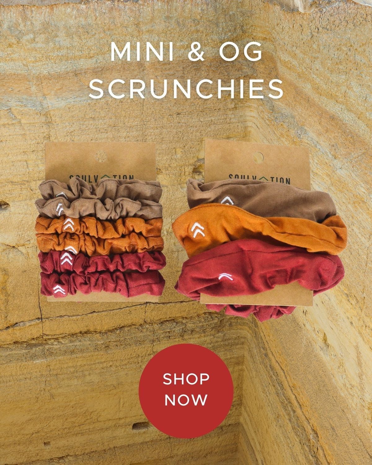 A bunch of scrunchies are stacked on top of each other on a wooden surface.