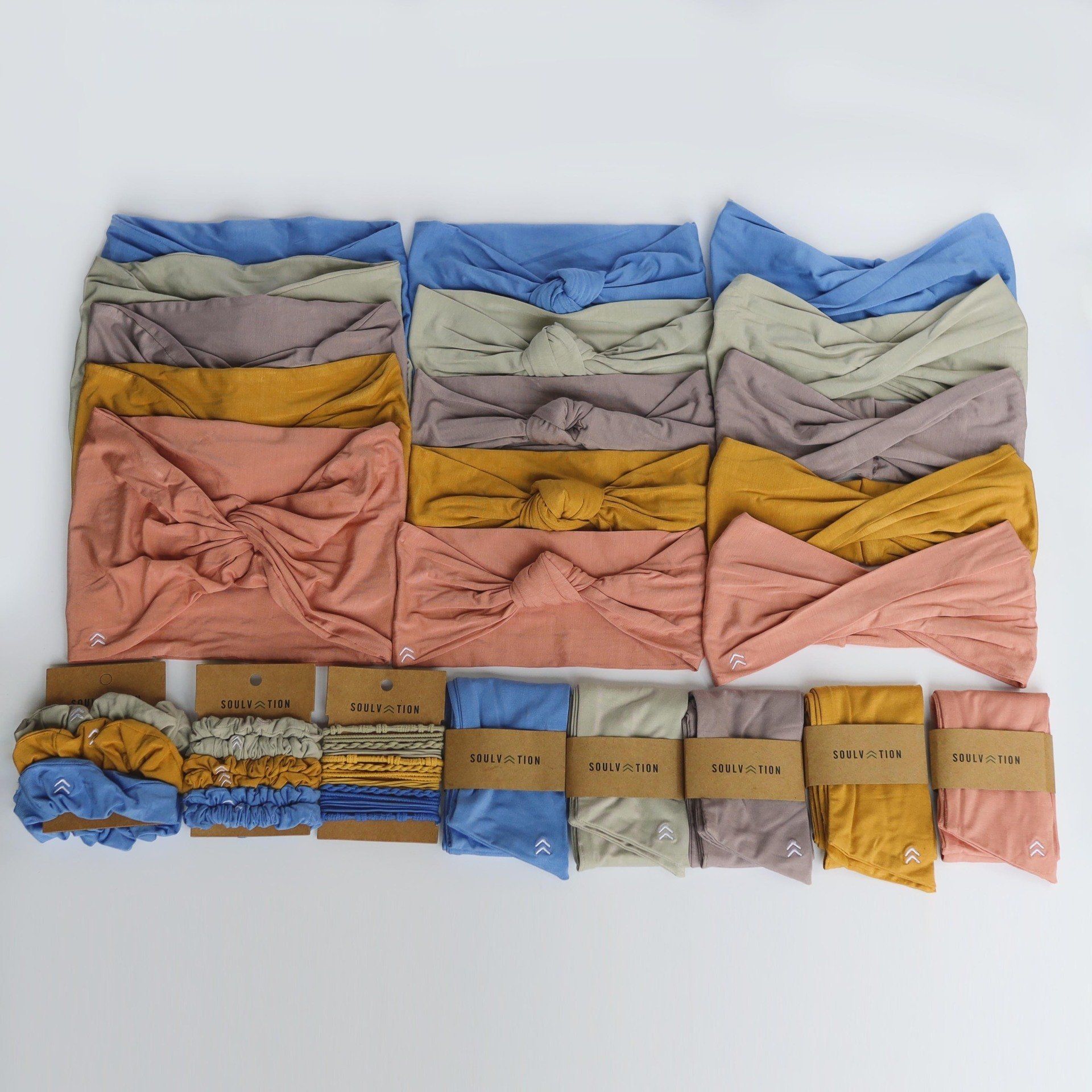 A bunch of headbands are stacked on top of each other on a table.