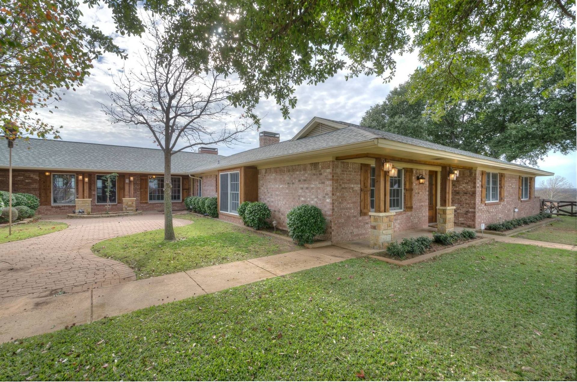 A large brick house with a walkway leading to it